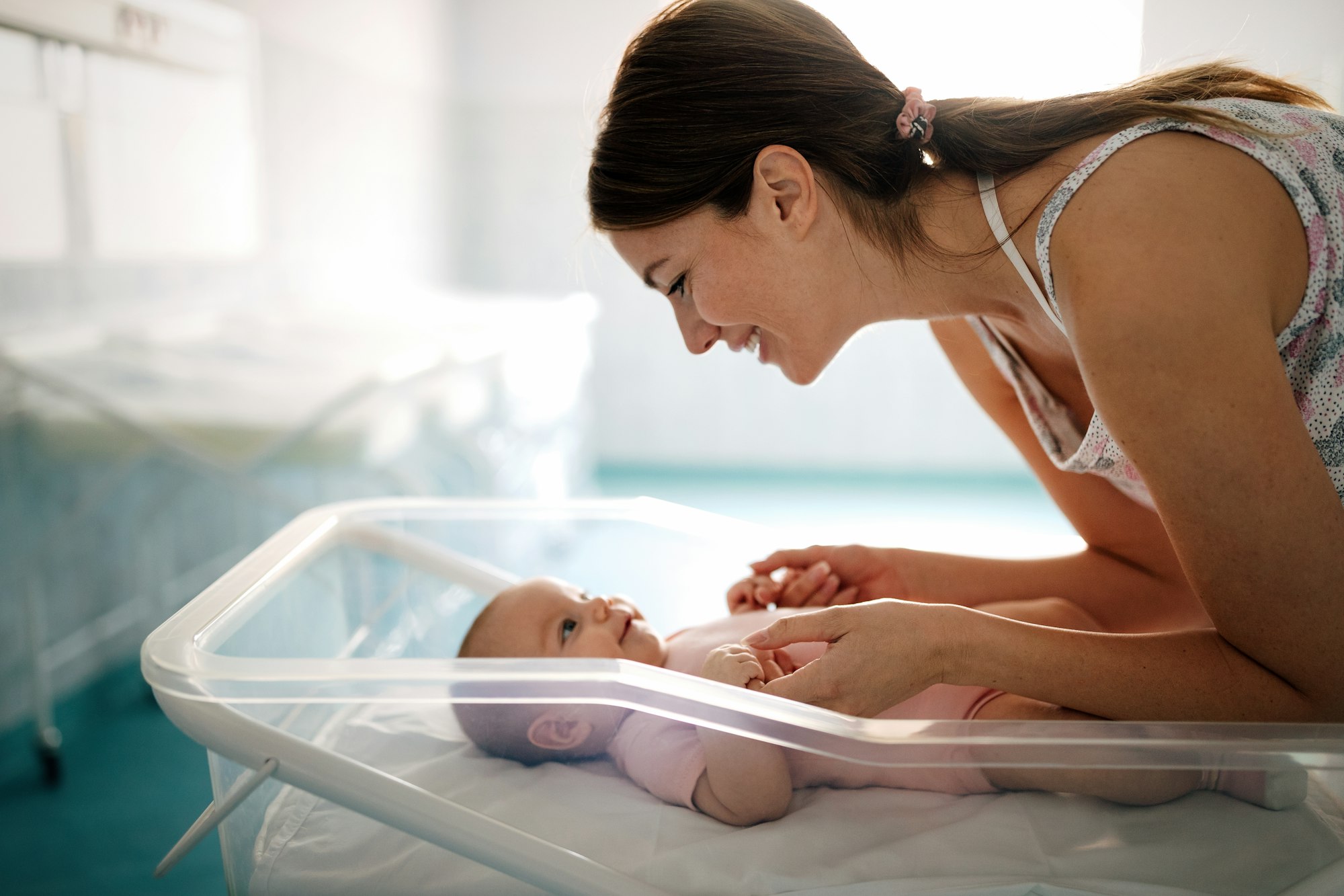 Mother holding her newborn baby child after labor in a hospital